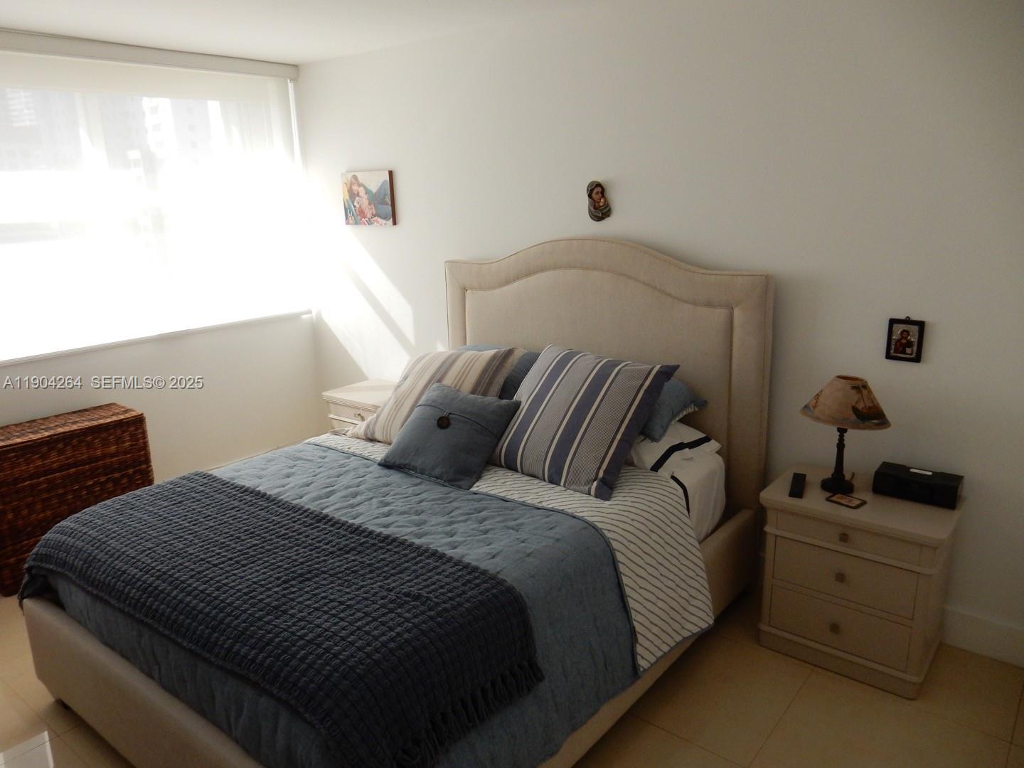 1420 Brickell Bay Drive, Unit 1406D Miami, FL 33131 - Photo 10 of 23 a bedroom with a bed and a window