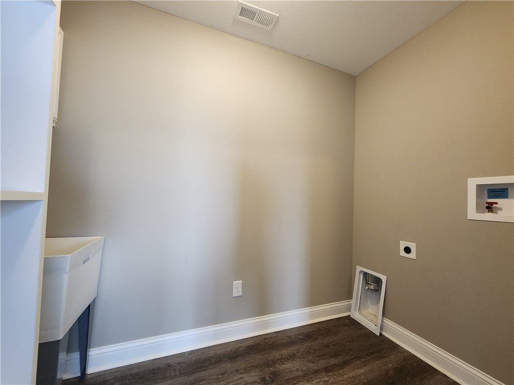 7441 Dodson Road Brookville, OH 45309 - Photo 4 of 50 This functional laundry area features durable flooring and essential hookups, ready for your appliances.