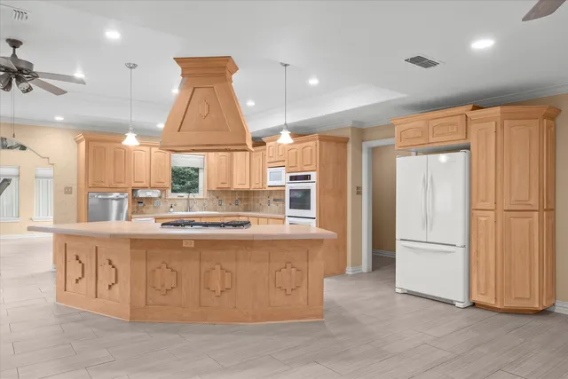 a kitchen with stainless steel appliances granite countertop a stove and a refrigerator