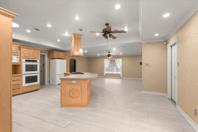 a view of a kitchen with a sink and a large window