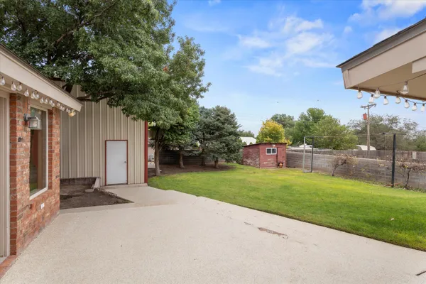 a backyard of a house with table and chairs