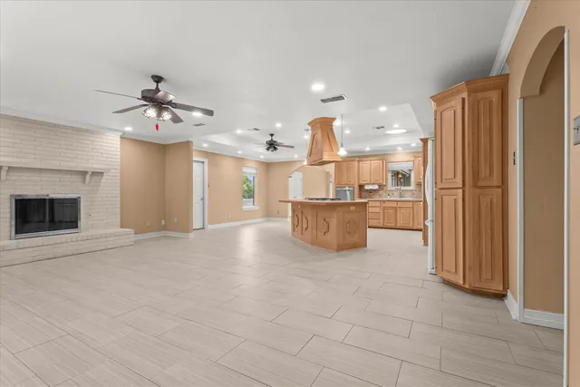 a view of a kitchen with a sink and a refrigerator