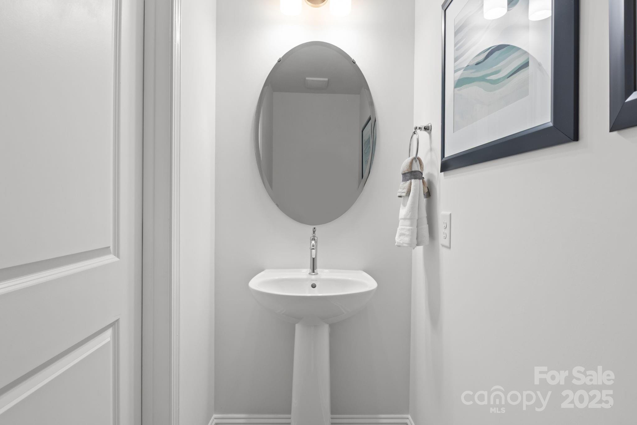 7716 Ethora Way, Unit 2 Charlotte, NC 28216 - Photo 12 of 30 a bathroom with a sink and a mirror