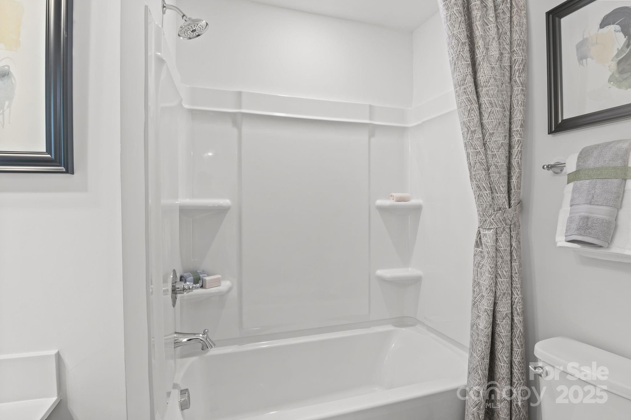 7716 Ethora Way, Unit 2 Charlotte, NC 28216 - Photo 23 of 30 a bathroom with a bathtub and a toilet