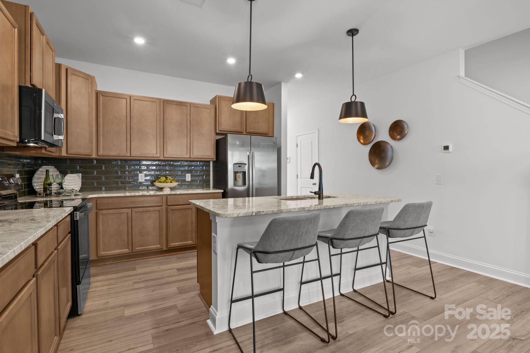 7716 Ethora Way, Unit 2 Charlotte, NC 28216 - Photo 6 of 30 a kitchen with a sink cabinets and window