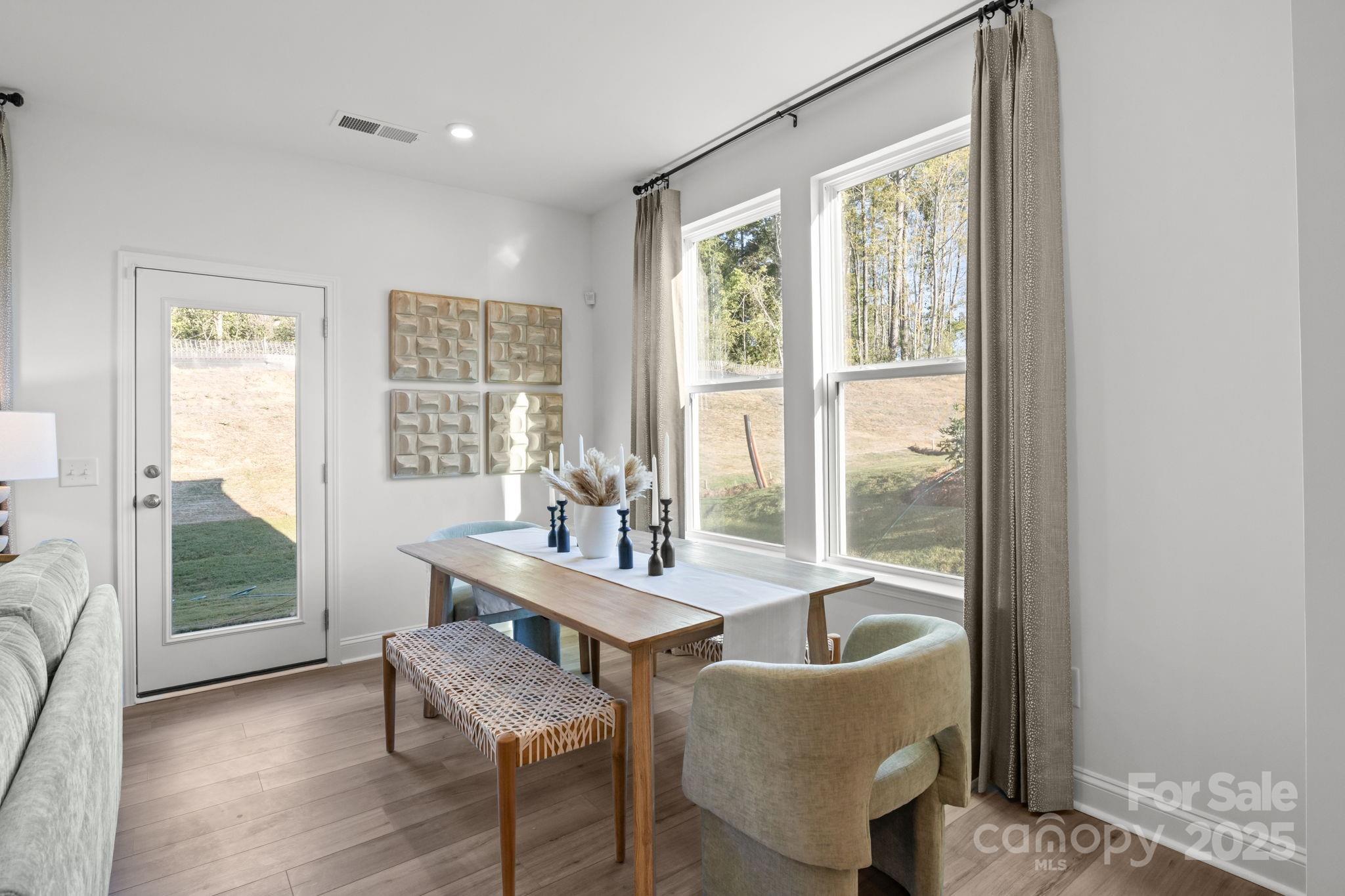 7716 Ethora Way, Unit 2 Charlotte, NC 28216 - Photo 7 of 30 a dining room with furniture and window