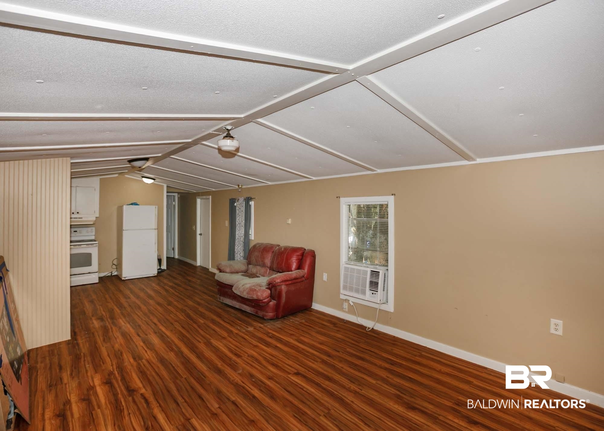 11998 Workman Avenue Foley, AL 36535 - Photo 40 of 59 Unfurnished room with wood finished floors and vaulted ceiling