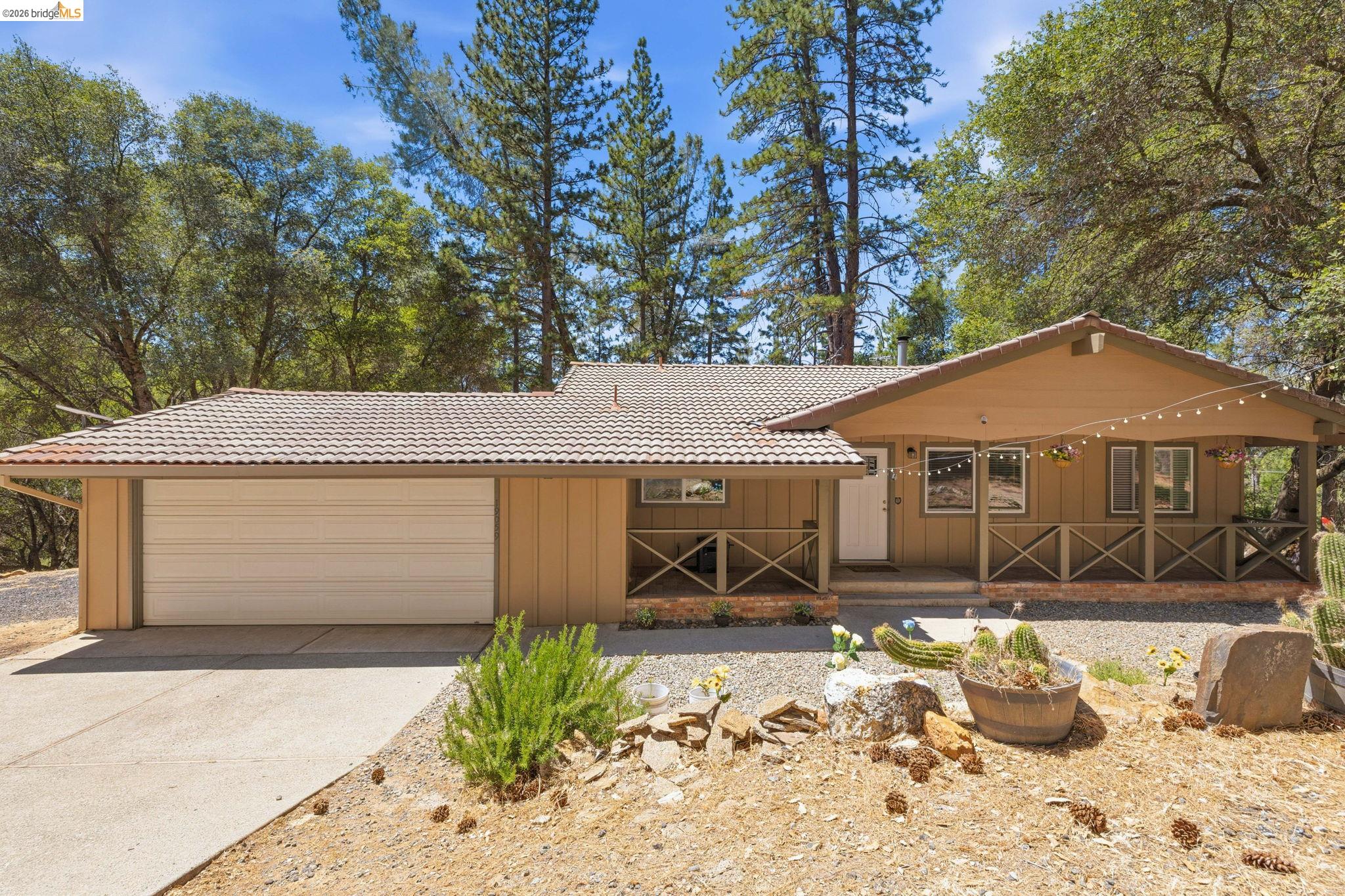19059 Raboul Court Groveland, CA 95321 - Photo 1 of 21 Exterior featuring a tiled roof, attached two-car garage, covered porch, and front entry