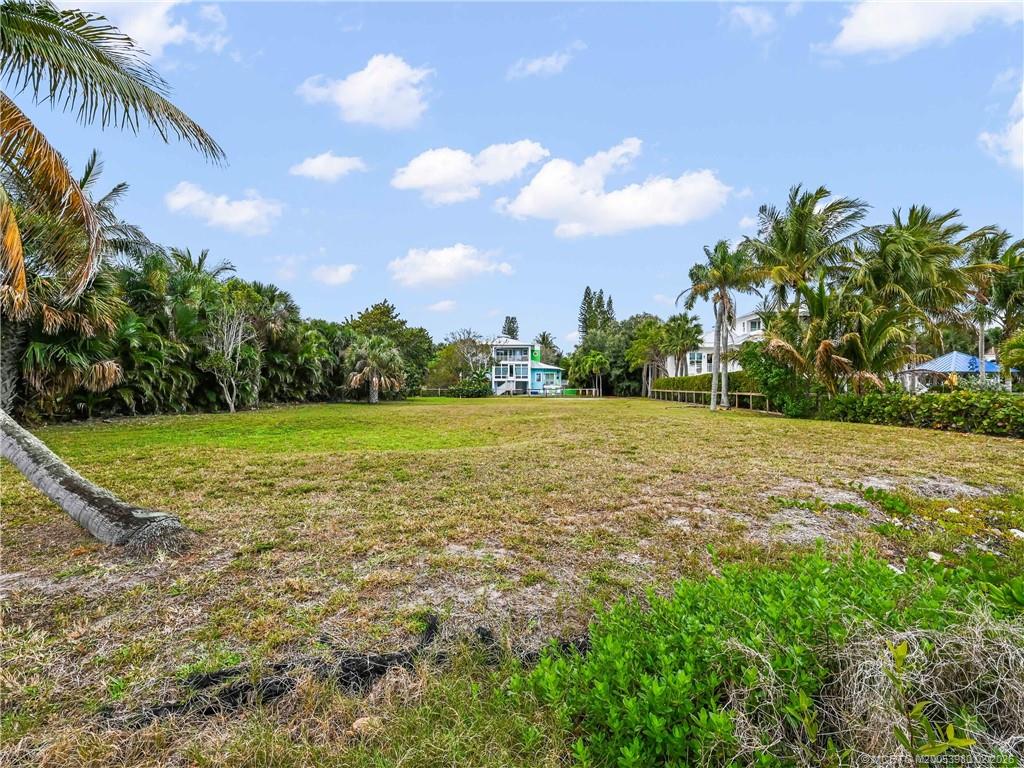 94 North Sewalls Point Road Stuart, FL 34996 - Photo 18 of 35 a view of a garden with a building in the background