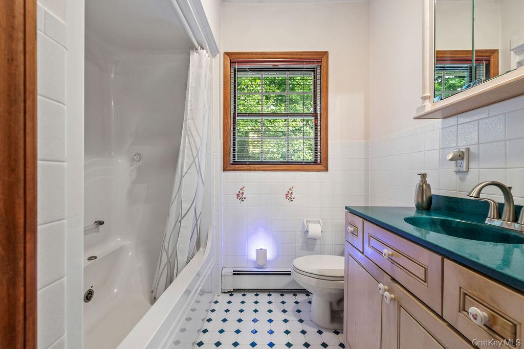 289 Seven Springs Mountain Road Monroe, NY 10950 - Photo 15 of 25 a bathroom with a granite countertop sink a toilet a window and shower