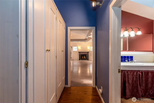 a view of a hallway with a livingroom and a bathroom with sink