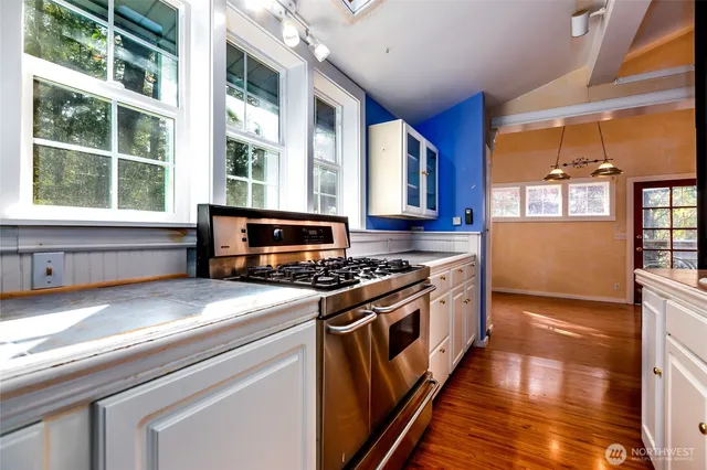a kitchen with stainless steel appliances granite countertop a stove and a sink