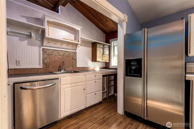 a kitchen with stainless steel appliances granite countertop a refrigerator and a sink