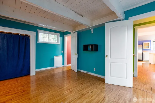 a view of a room with an empty room and wooden floor