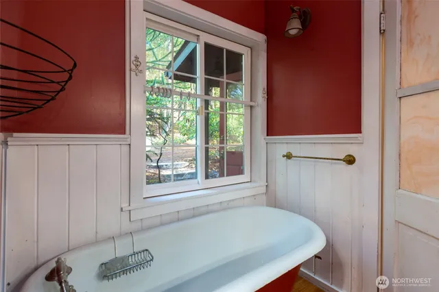 a bathroom with a tub and a shower