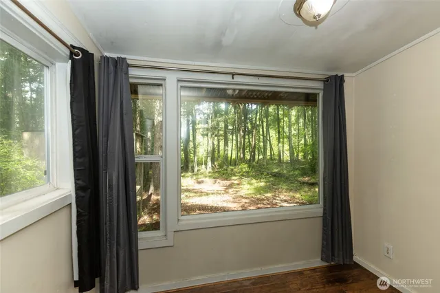 a view of an empty room with wooden floor