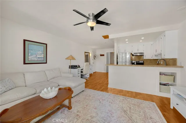 a living room with furniture and kitchen view