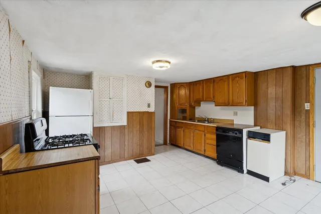 a kitchen with a refrigerator and a stove