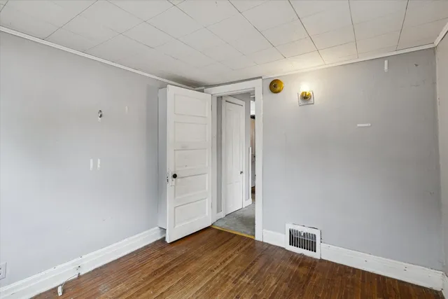 a view of an empty room with wooden floor