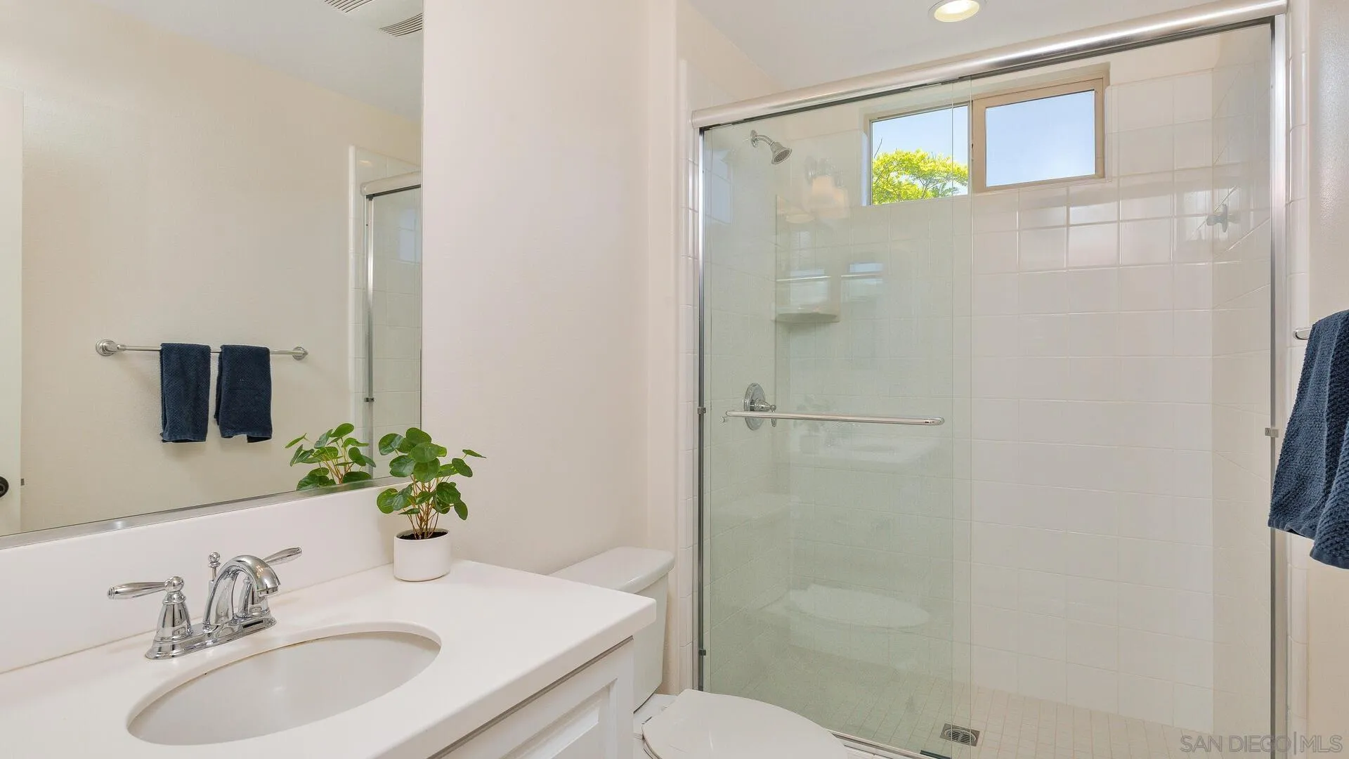15575 Tanner Ridge Road San Diego, CA 92127 - Photo 21 of 41 a bathroom with a granite countertop sink a toilet and shower