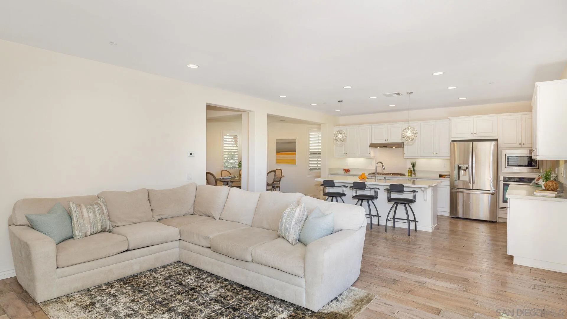 15575 Tanner Ridge Road San Diego, CA 92127 - Photo 8 of 41 a living room with furniture with kitchen view and a wooden floor