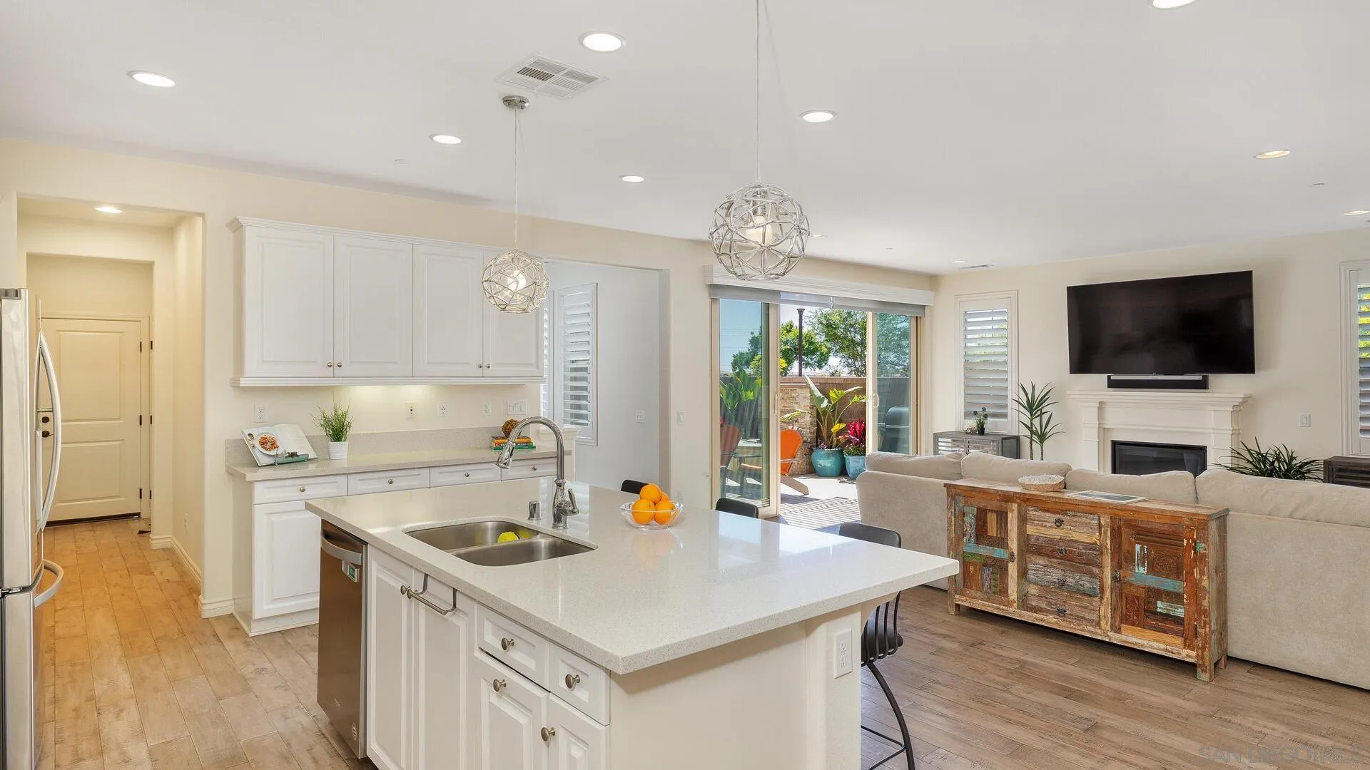 15575 Tanner Ridge Road San Diego, CA 92127 - Photo 10 of 41 a kitchen with stainless steel appliances a sink a stove a refrigerator cabinets and living room view