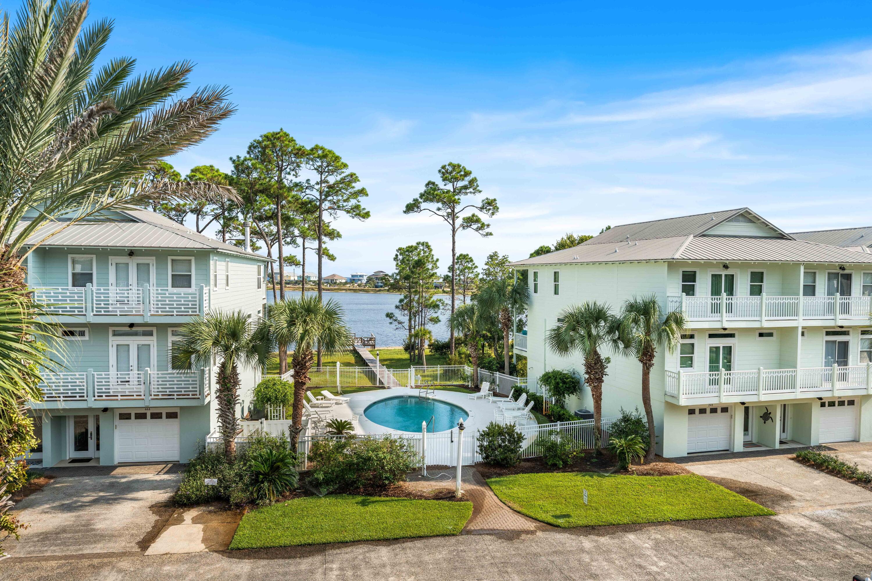 33 Dune Breeze Lane, Unit H2 Santa Rosa Beach, FL 32459 - Photo 12 of 54 a front view of a residential apartment building with a yard and potted plants