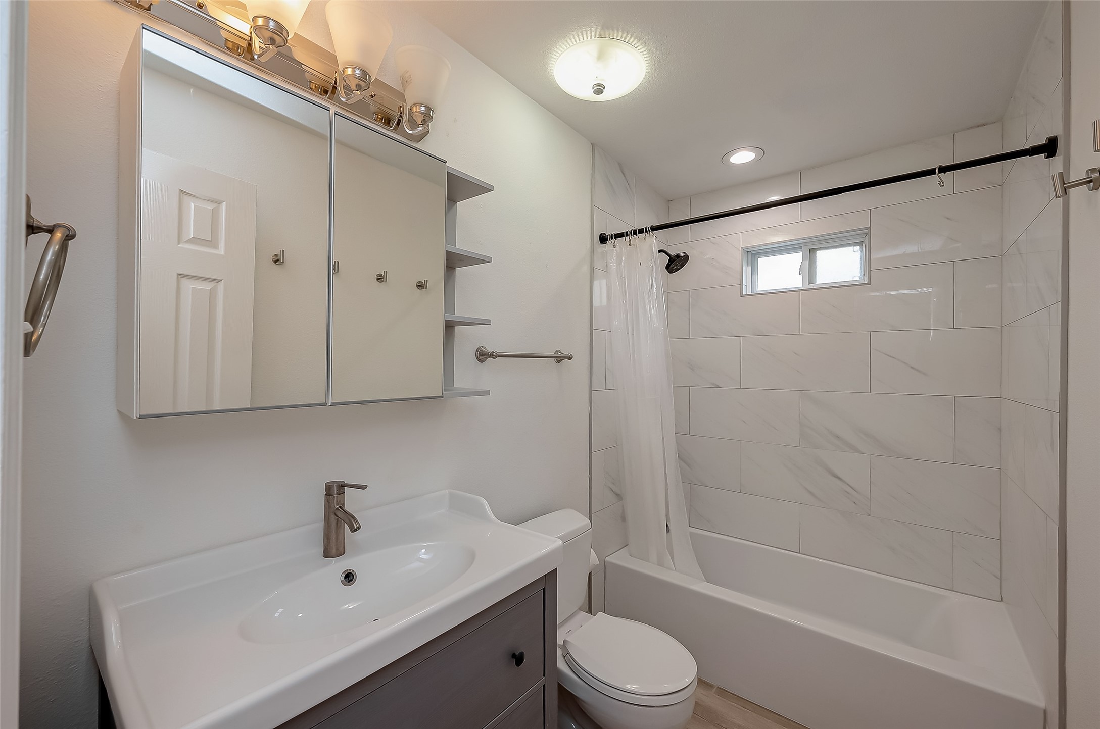 915 Adele Street Houston, TX 77009 - Photo 14 of 23 a bathroom with a sink a toilet and shower