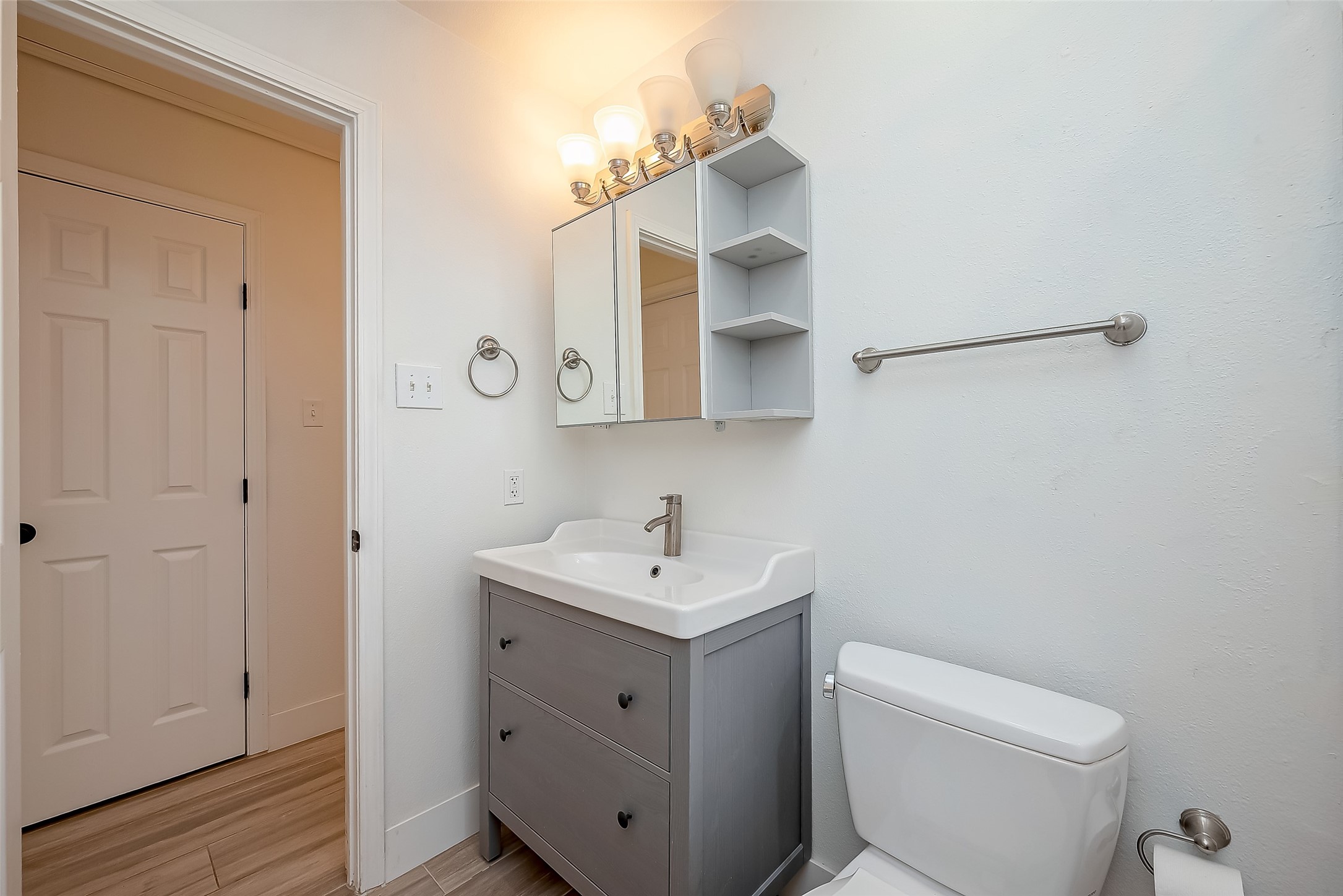 915 Adele Street Houston, TX 77009 - Photo 15 of 23 a bathroom with a toilet sink and mirror