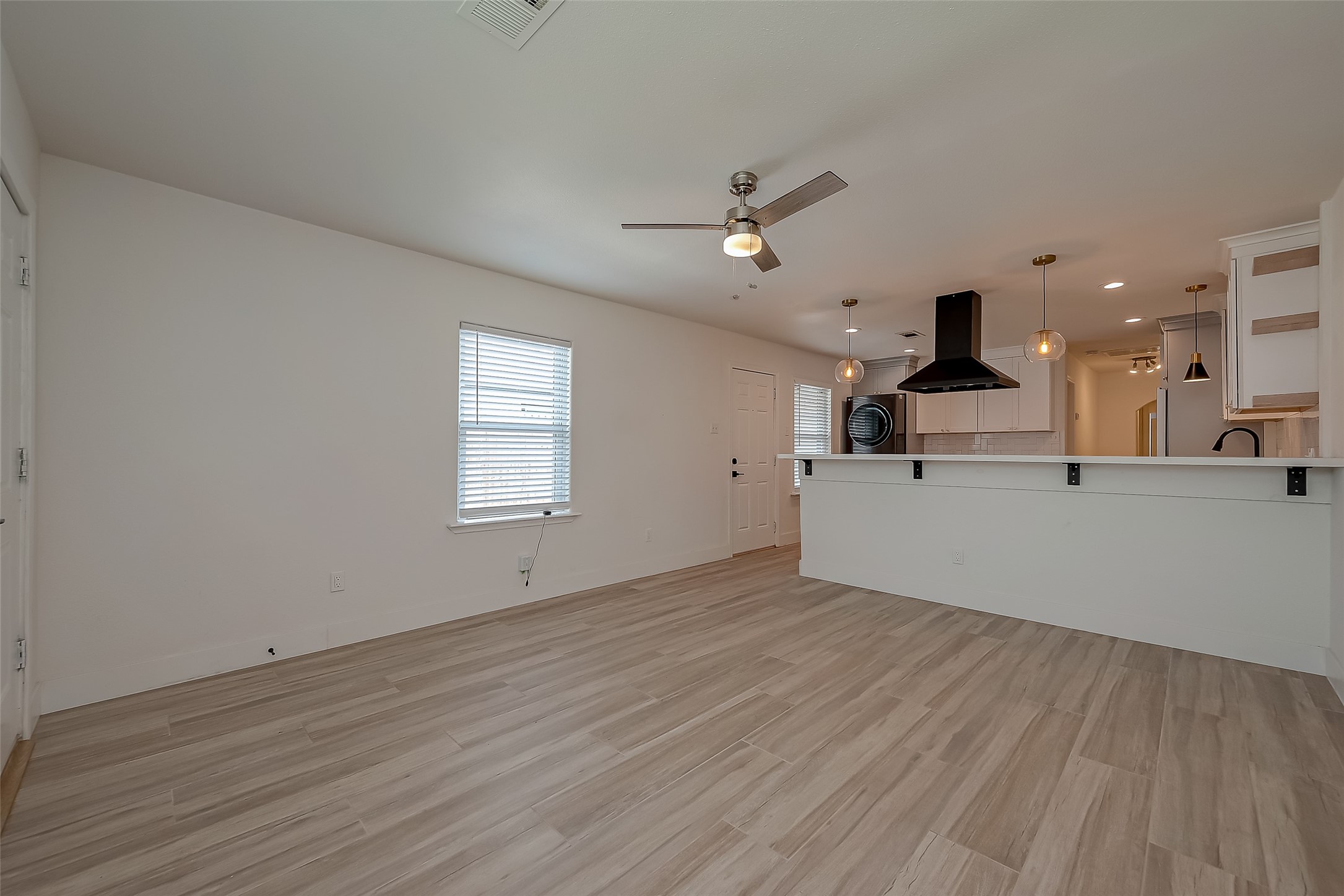 915 Adele Street Houston, TX 77009 - Photo 7 of 23 a view of a kitchen with wooden floor and a kitchen view
