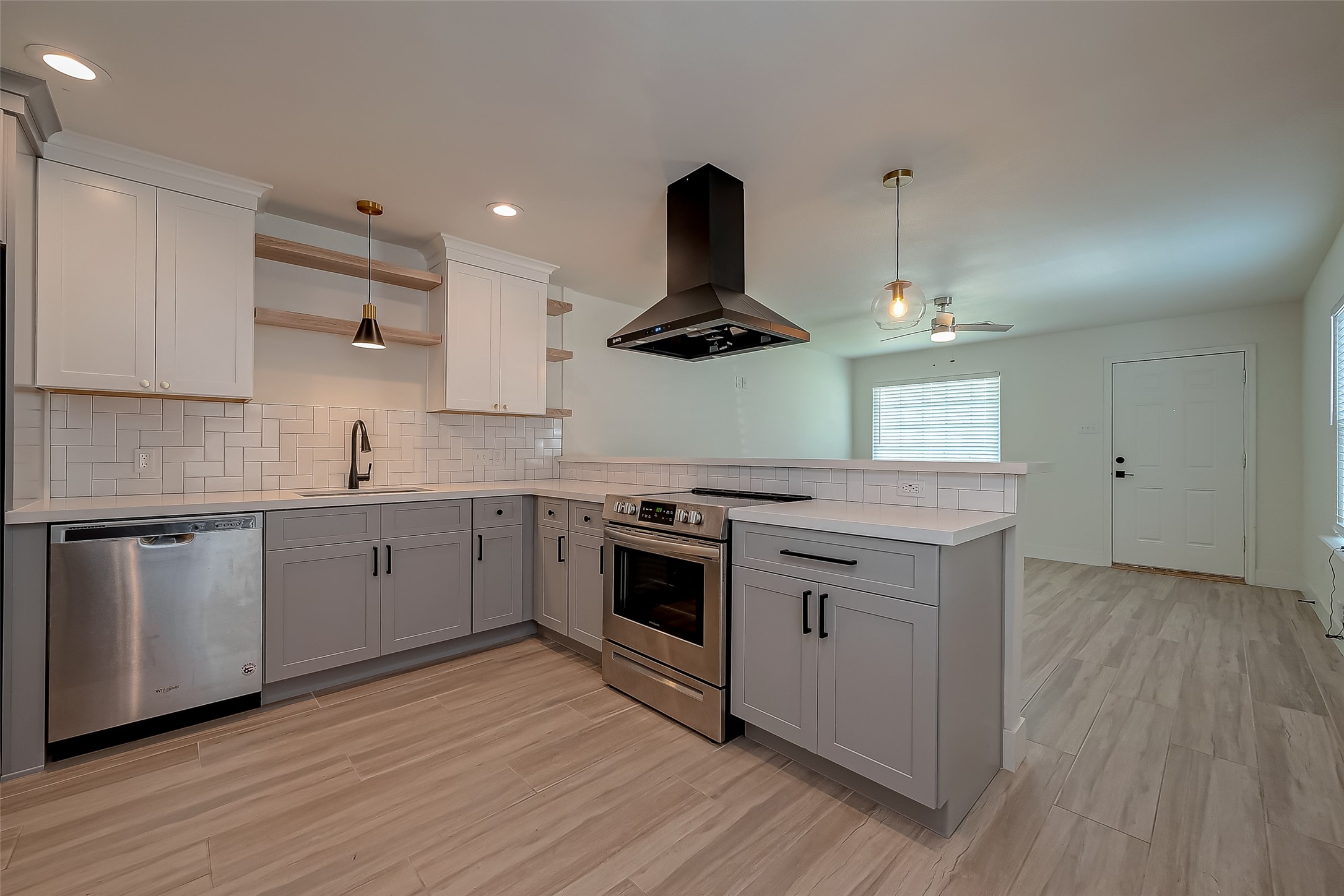 915 Adele Street Houston, TX 77009 - Photo 8 of 23 a kitchen with a sink stainless steel appliances and wooden floor