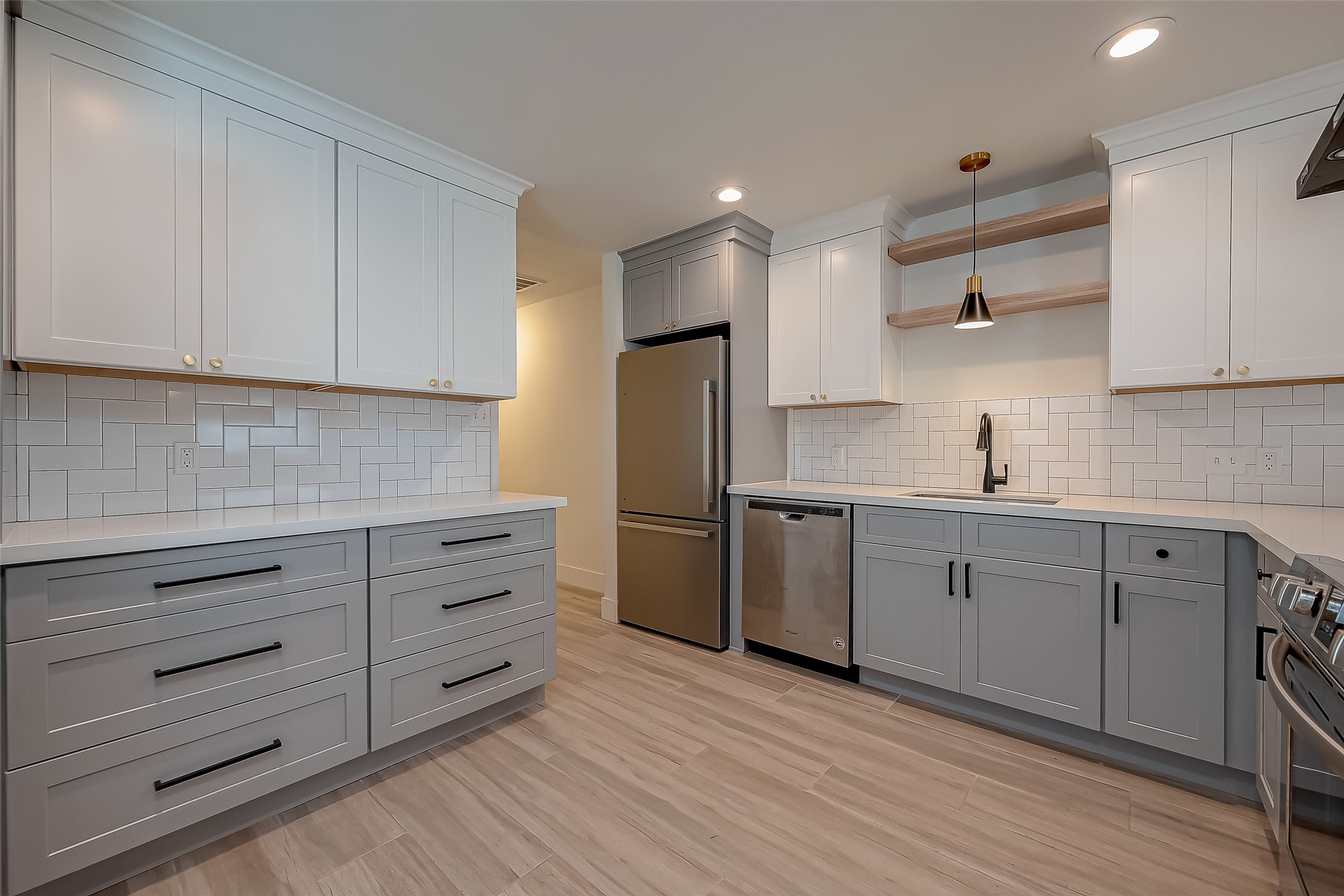 915 Adele Street Houston, TX 77009 - Photo 9 of 23 a kitchen with appliances cabinets and a sink