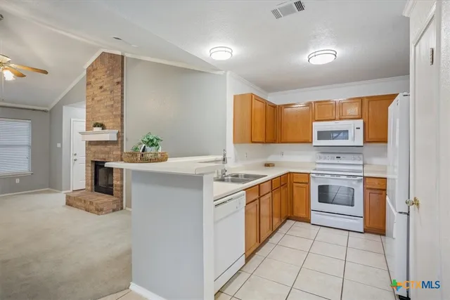 a kitchen with stainless steel appliances a stove sink and cabinets