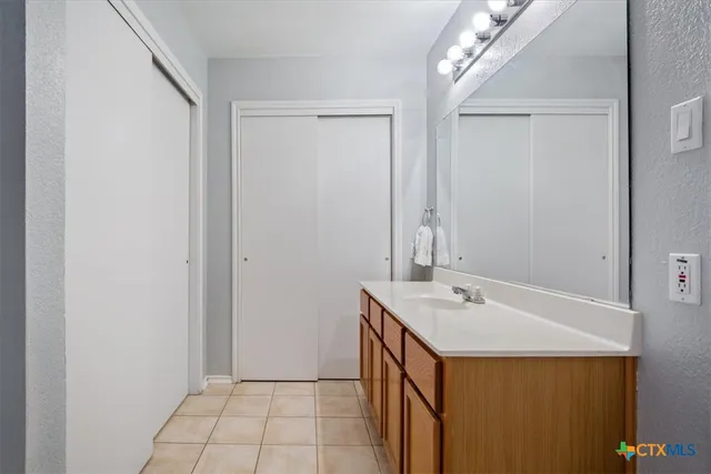a bathroom with a sink a mirror and a shower