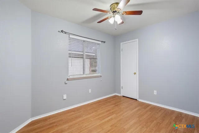 a view of a room with a ceiling fan and a window