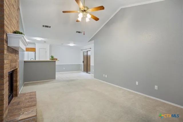 a view of a kitchen with a sink and a ceiling fan