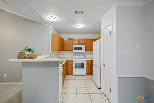 a kitchen with stainless steel appliances a stove a sink and a refrigerator