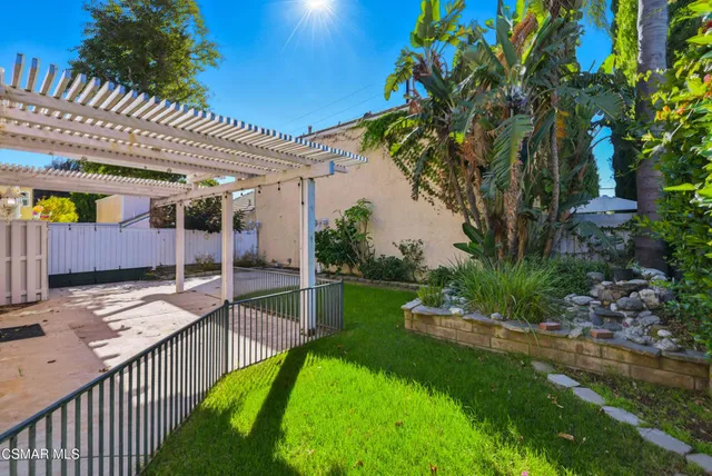 a view of a house with a yard and sitting area