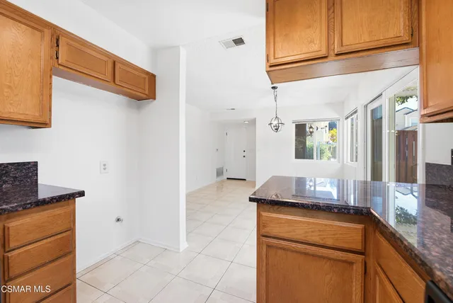 a kitchen with stainless steel appliances granite countertop a sink and cabinets