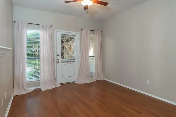an empty room with closet and windows