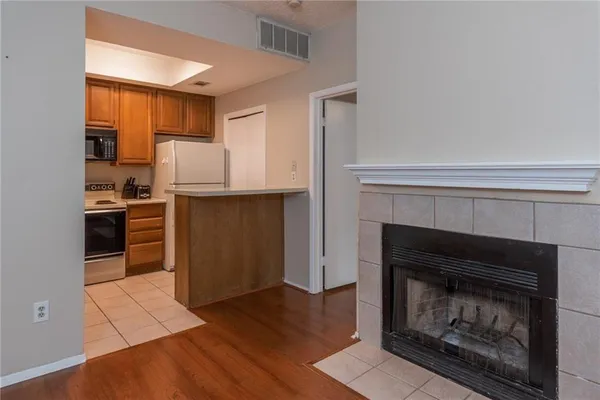 a kitchen with a stove and a fireplace