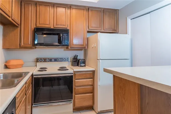 a kitchen with a stove microwave and refrigerator