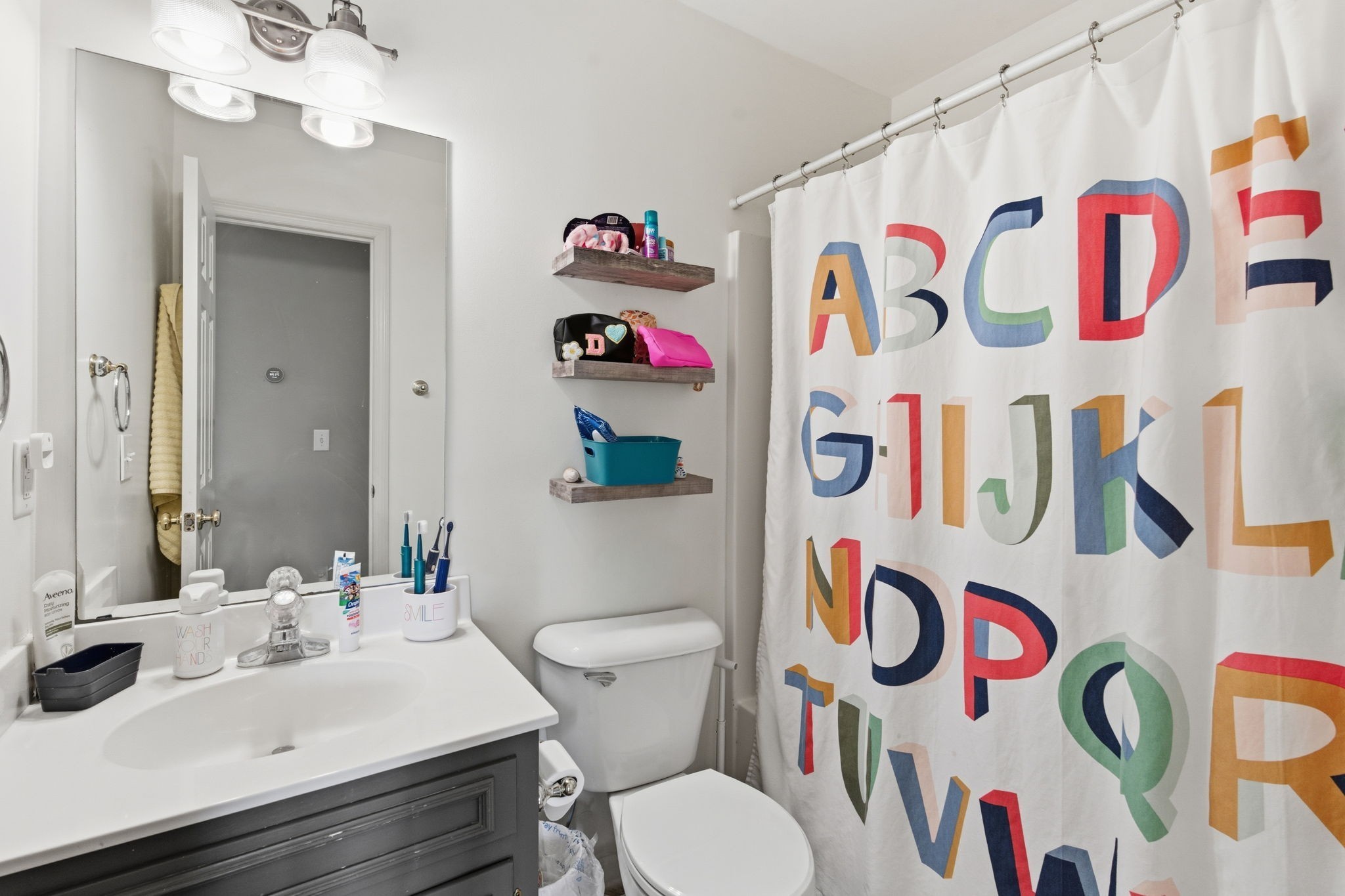 1766 Witt Way Drive Spring Hill, TN 37174 - Photo 22 of 36 a bathroom with a sink a toilet and a curtain