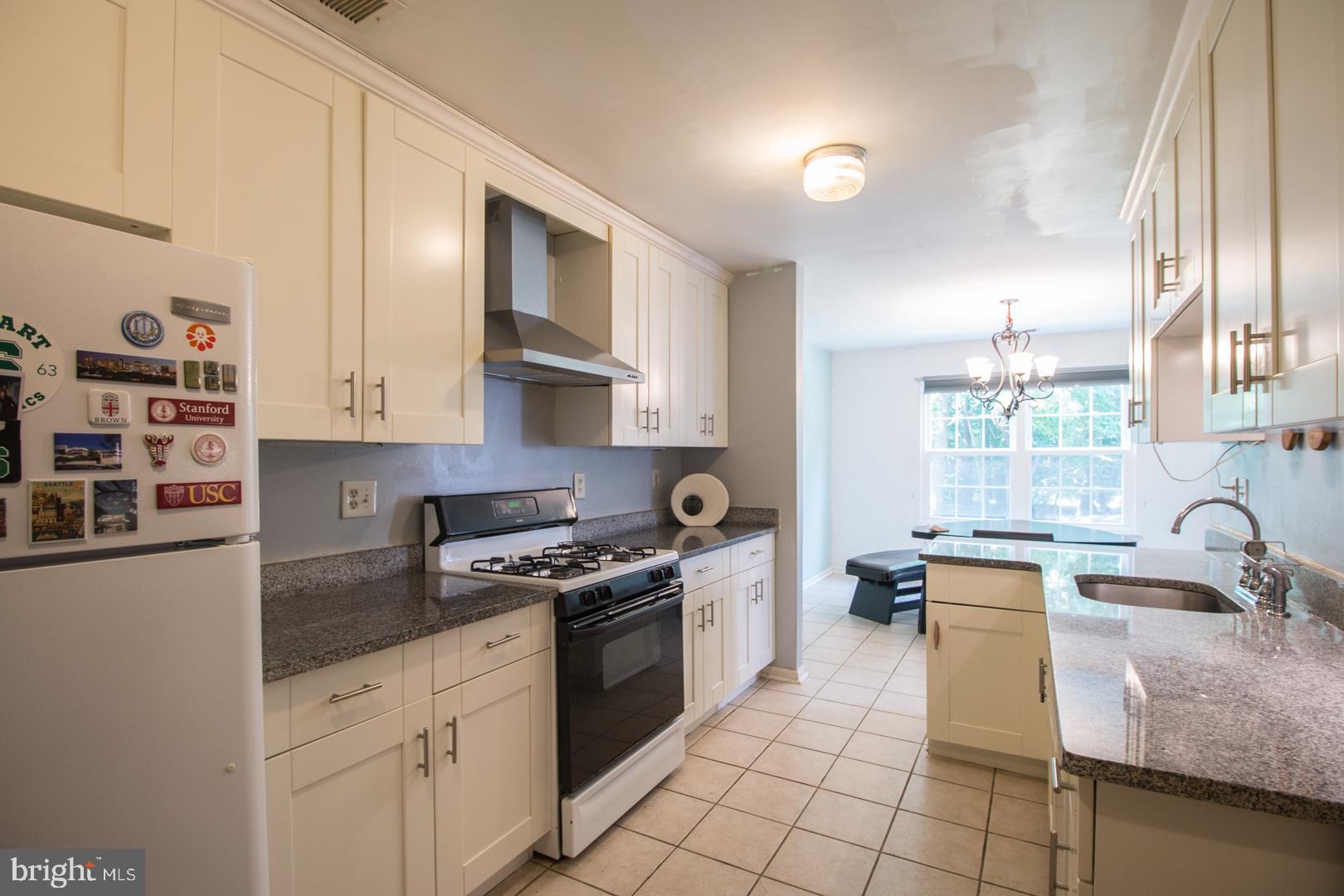 15 B Andover Circle, Unit B Princeton, NJ 08540 - Photo 5 of 14 a kitchen with stainless steel appliances granite countertop a sink stove and cabinets