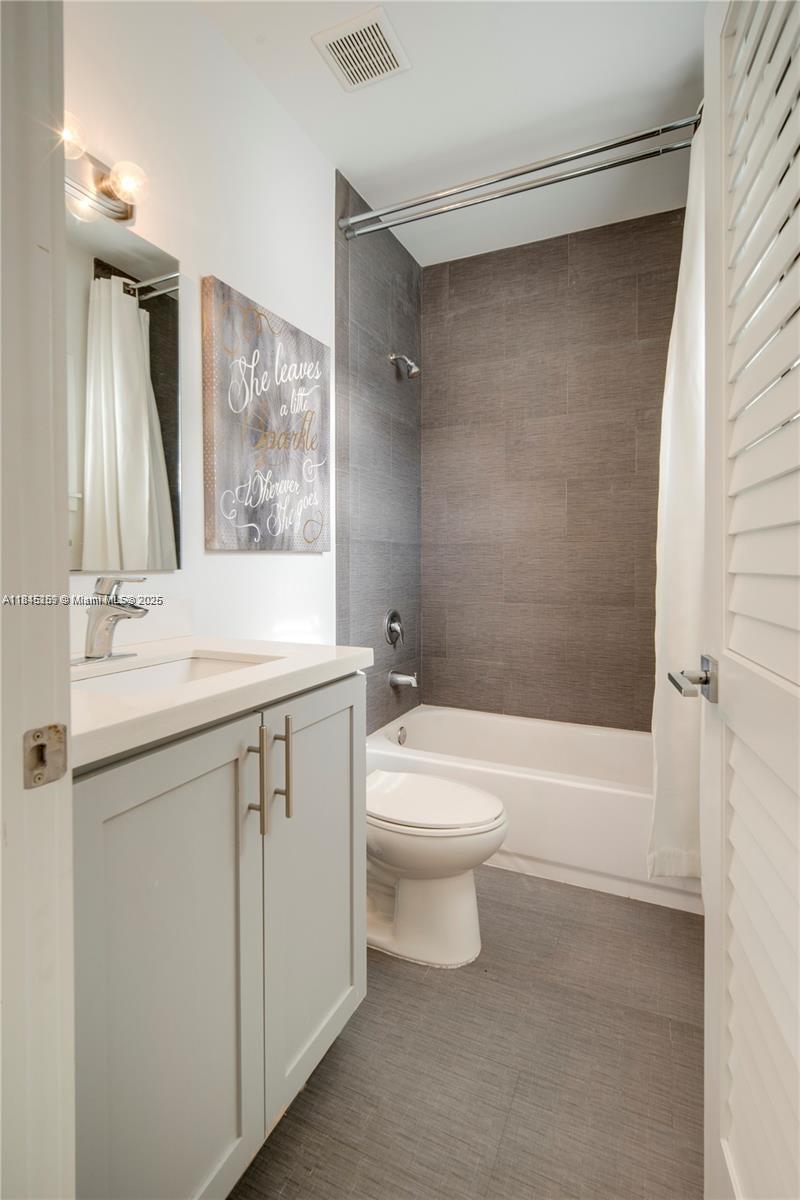 106 Florida Avenue Coral Gables, FL 33133 - Photo 17 of 34 a bathroom with a sink a toilet and shower