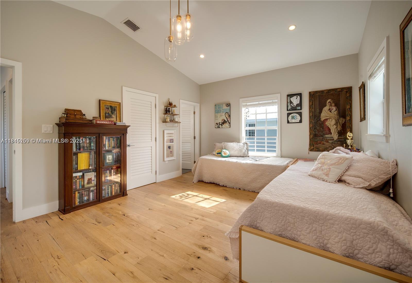 106 Florida Avenue Coral Gables, FL 33133 - Photo 18 of 34 a bedroom with a large bed and a dresser