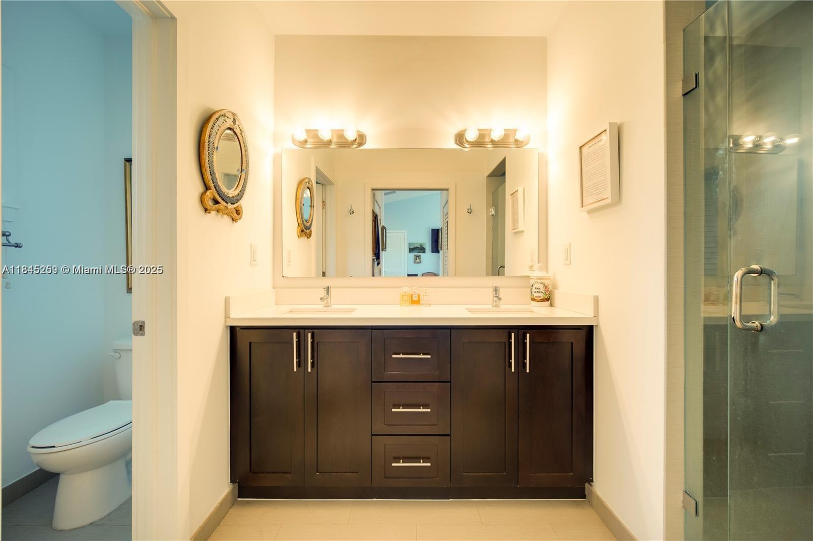 106 Florida Avenue Coral Gables, FL 33133 - Photo 21 of 34 a bathroom with a sink vanity and a mirror