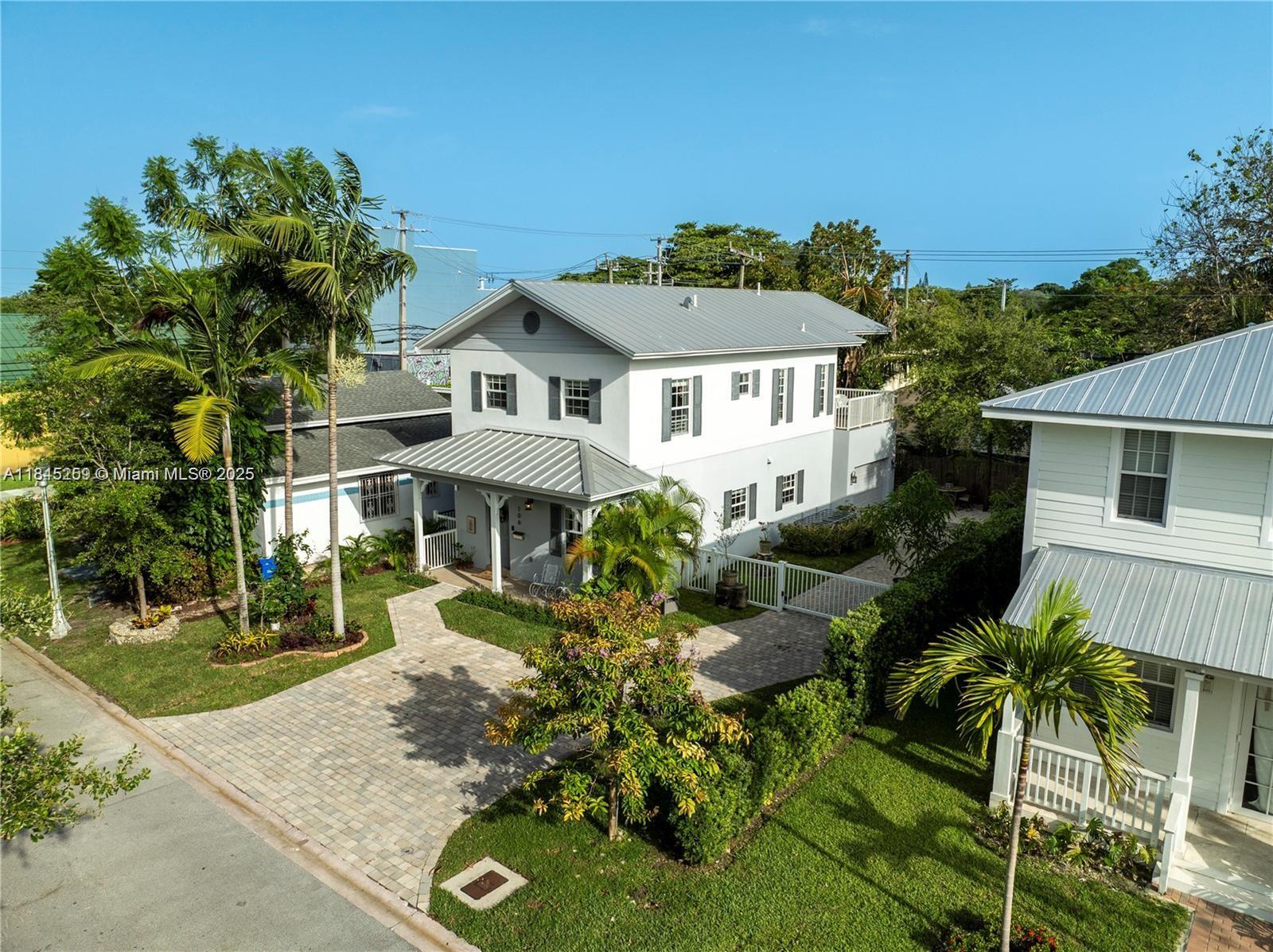 106 Florida Avenue Coral Gables, FL 33133 - Photo 28 of 34 a front view of a house with a yard