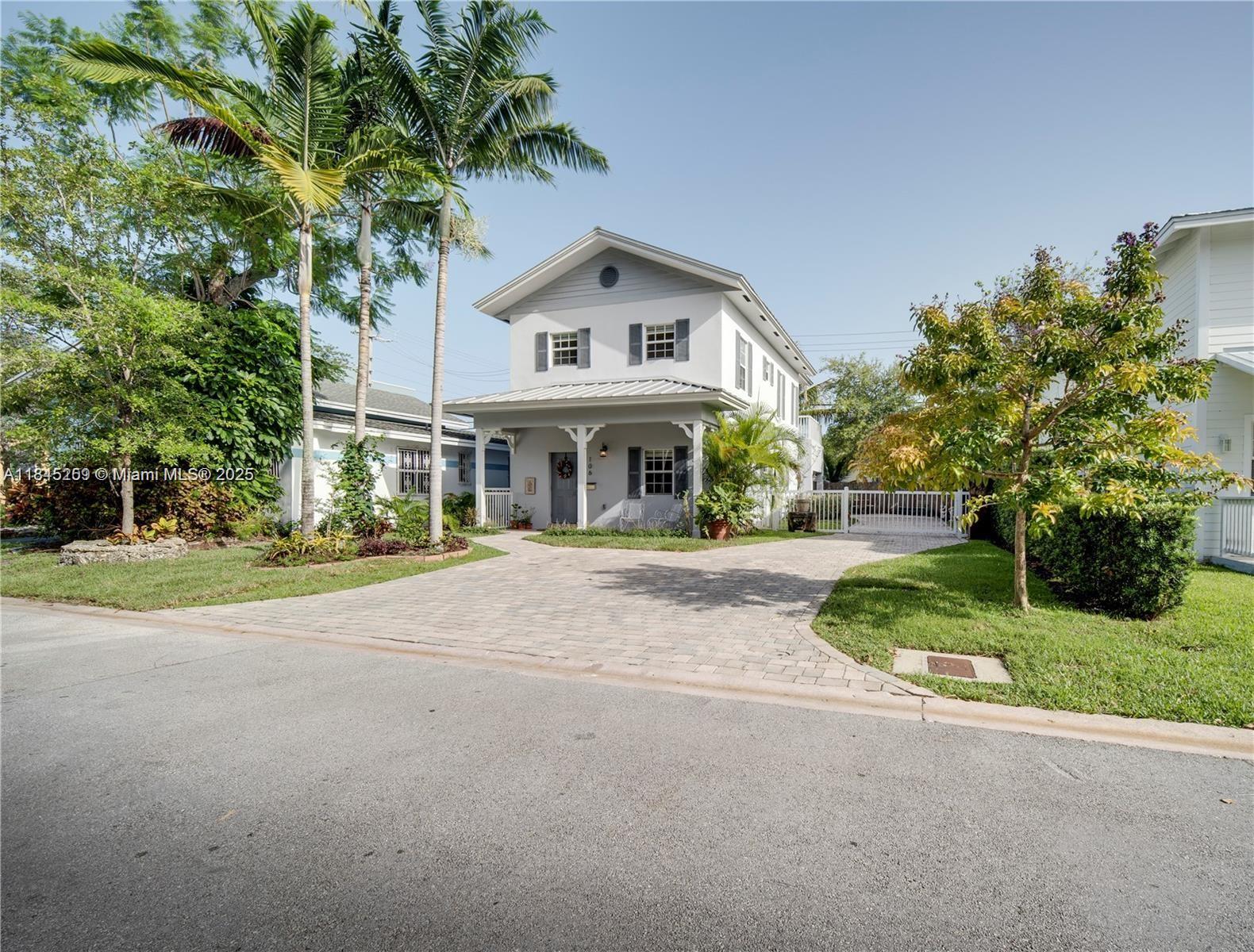 106 Florida Avenue Coral Gables, FL 33133 - Photo 34 of 34 a front view of a house with a yard and garage