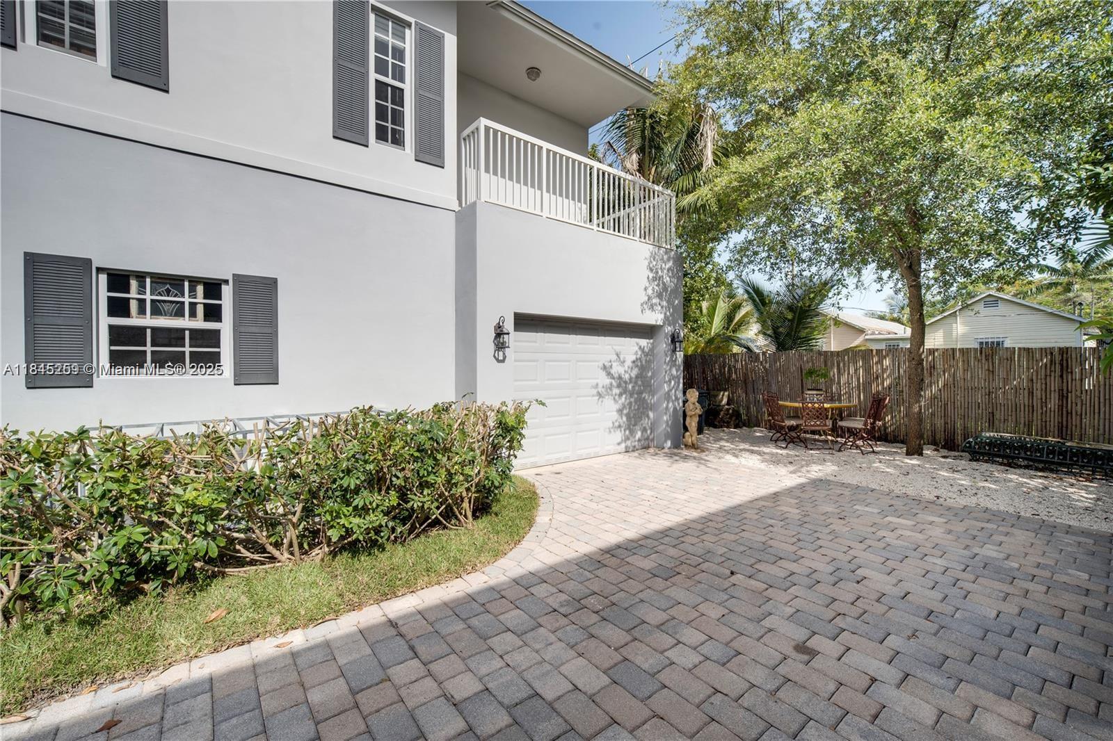106 Florida Avenue Coral Gables, FL 33133 - Photo 4 of 34 a front view of a house with garden